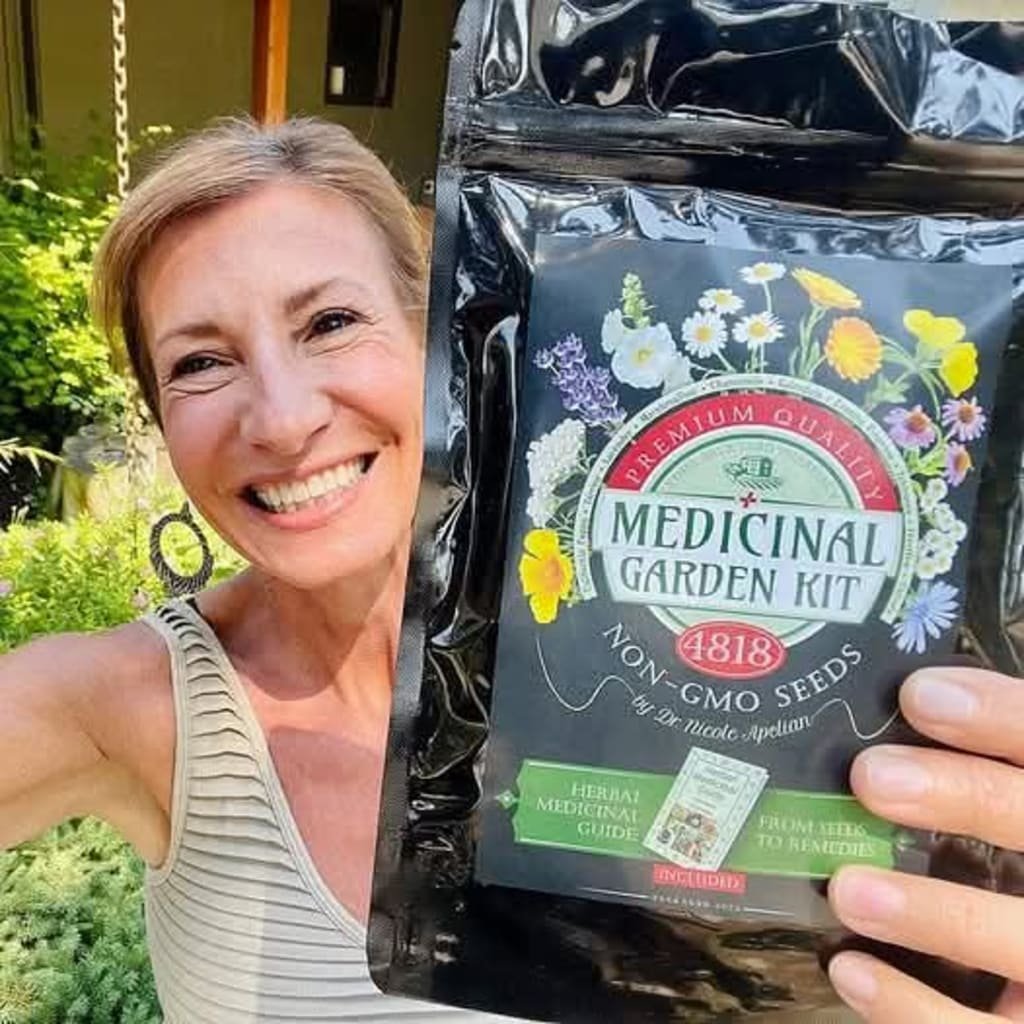 Woman holding the Medicinal Garden Kit — 4818 Non-GMO Seeds by Dr. Nicole Apelian